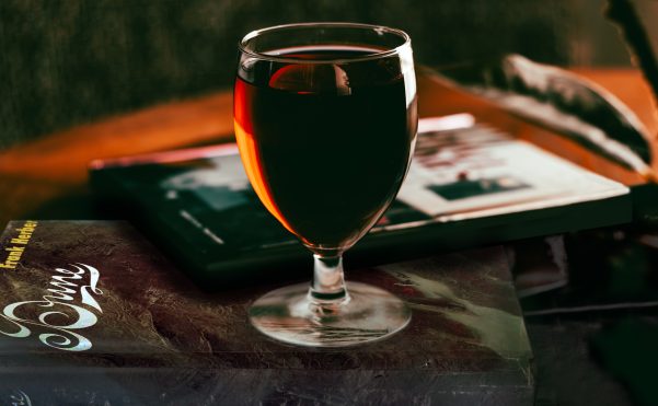 mocktail drink glass atop a book