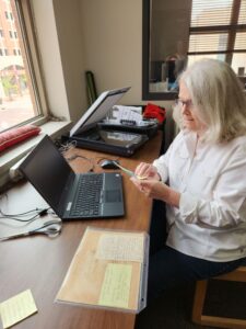 Volunteer Sandy digitizing materials