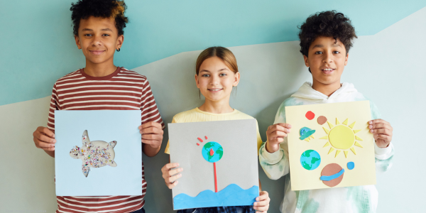 children holding artwork