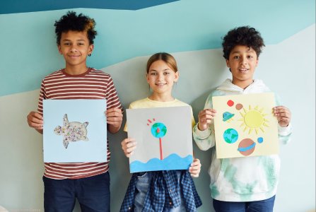 children holding artwork