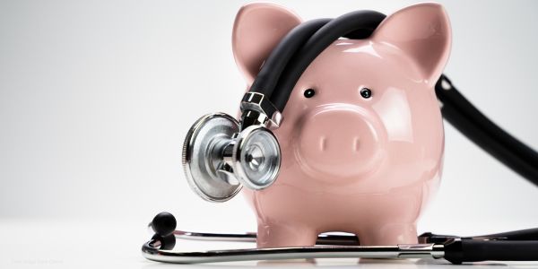 piggy bank and stethoscope