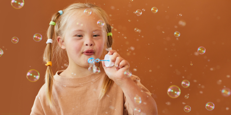 child blowing bubbles