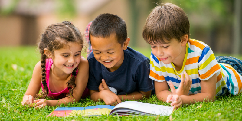 children reading outside