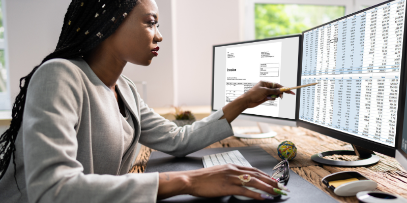 person on computer with spreadsheets open