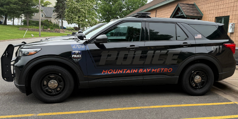 A black police SUV with "POLICE" and "MOUNTAIN BAY METRO" on the side.