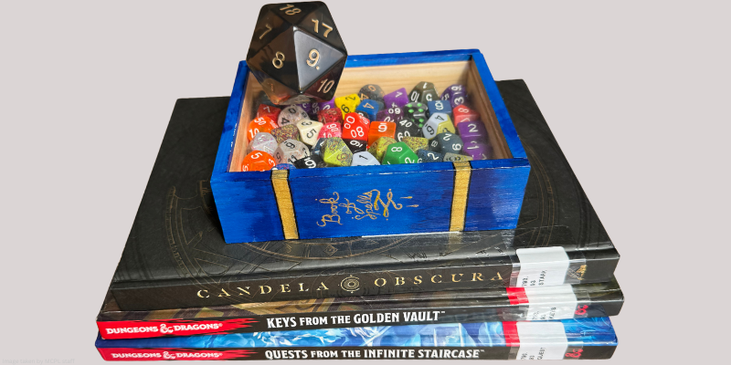 dice tray with dice on top of dungeons and dragons books