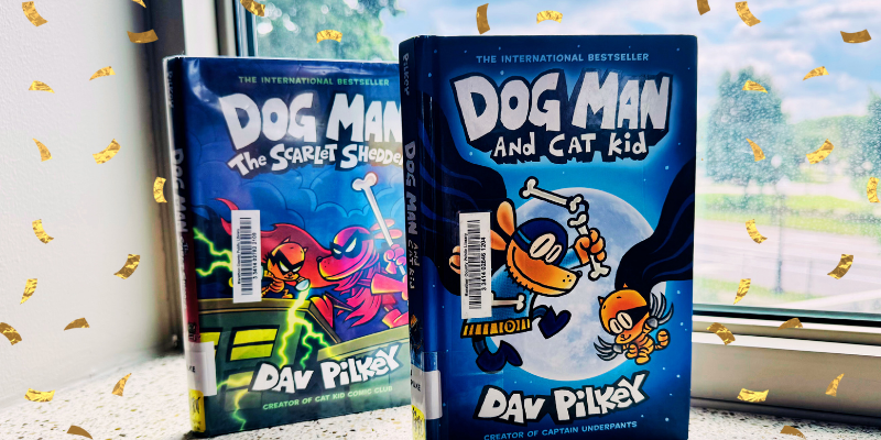 two dog man books by dav pilkey set on window sill
