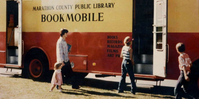 historic photo of the MCPL bookmobile and patrons using the bookmobile