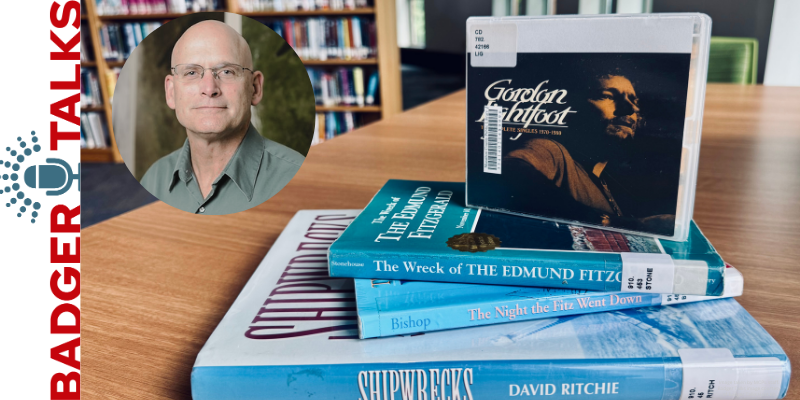 A stack of shipwreck-themed books and a Gordon Lightfoot CD, with a "Badger Talks" overlay featuring presenter Steve Ackerman's image