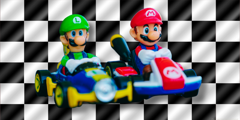 black and white checkered background with figurines of luigi and mario on go carts.