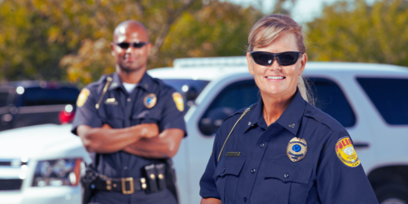 two police officers outside smiling