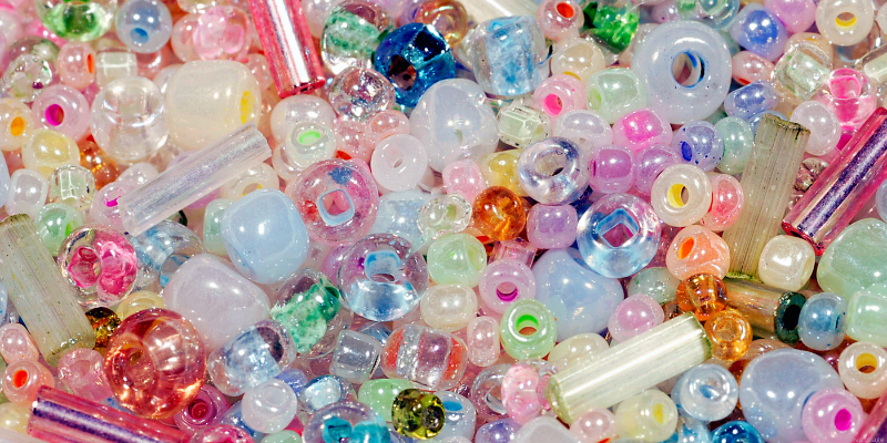 A colorful assortment of variously shaped and sized beads in a close-up view.