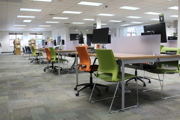 Computer workstations and colorful chairs.