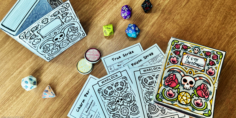dice, cards, and a decorative papercard box featuring skull and rose designs.