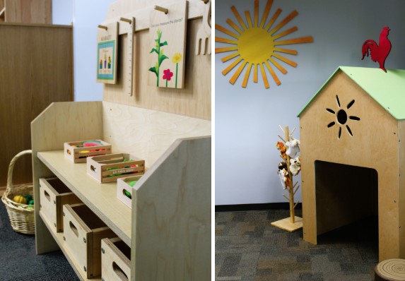 A children's activity room with a wooden shelf unit and a small house structure.