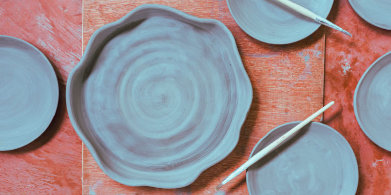 variety of smooth clay dishes on a table